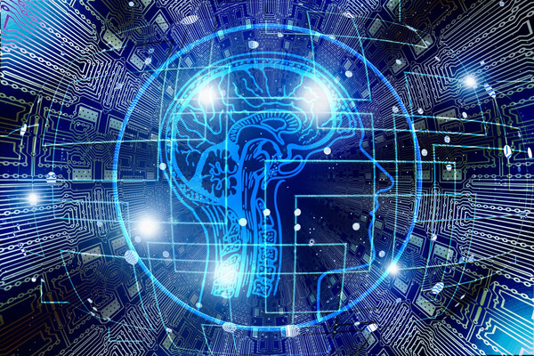 Abstract scan of brain overlapping a computer chip network.