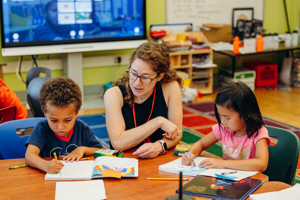 elementary age students with teacher