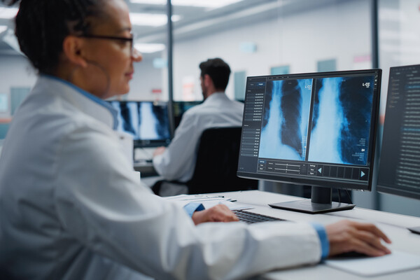 A scientific researcher on a computer in a lab.