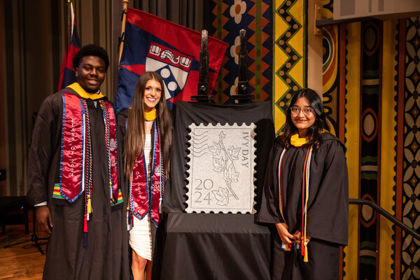 Class of 2024 students stand with Ivy Day stone