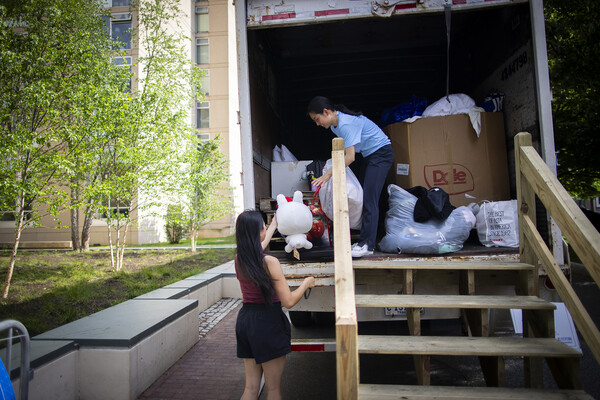 Person gives item to another person staffing donation truck