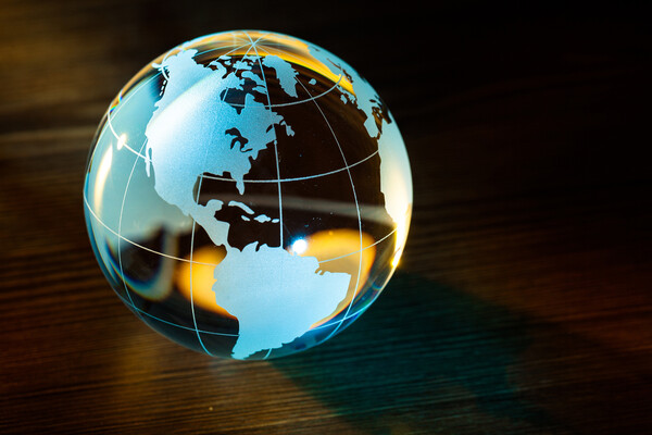 A glass globe sitting on a woodend table shows north and south America.