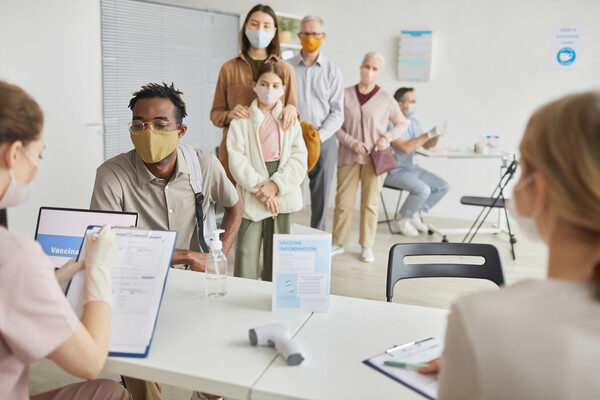 A line of people waiting to register for vaccines.