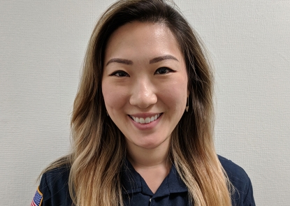 Young woman with long hair in a blue work uniform