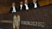 Judges enter the hall of the International Court of Justice