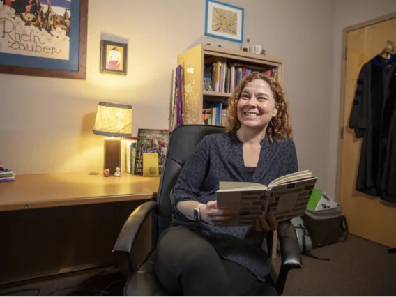 Chantelle Warner sits in her office with a book