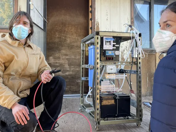 Two researchers configuring a filtration unit