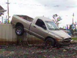 Oil stained vehicle and fence