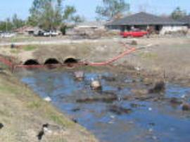 Boom placed to catch residual oil in canal