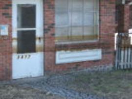 Oil staining along exterior of house due to oil spill