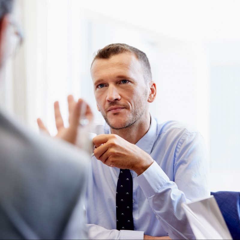 Colleague Communicating With Businessman In Office