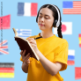 woman wearing headphones and writing on a notebook, background with flags