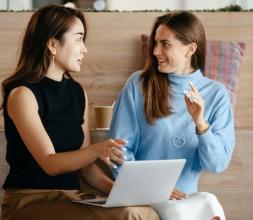 Two female teachers discuss lesson plans