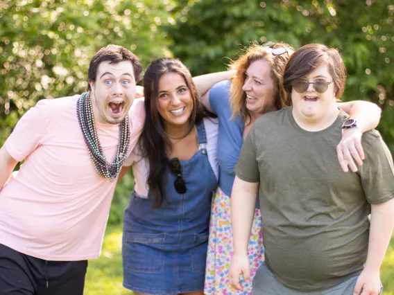 A group of 4 young people smiling