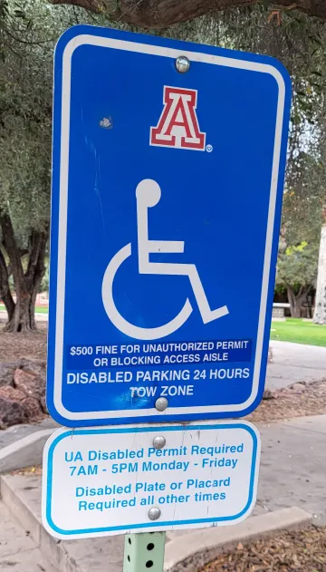 a blue and white handicapped parking sign