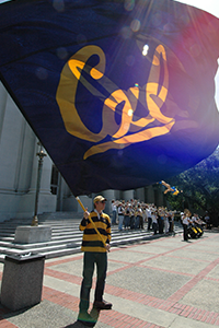 Student waving a Cal flag.