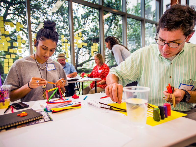 People constructing objects with building blocks