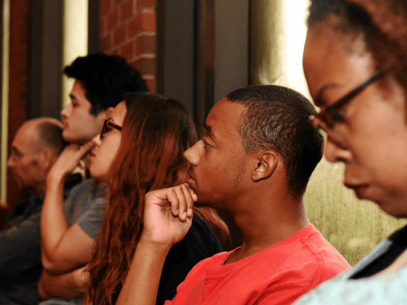 People listening to speaker in meeting room