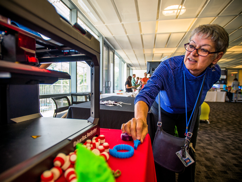 Staff member creating objects on 3d printer