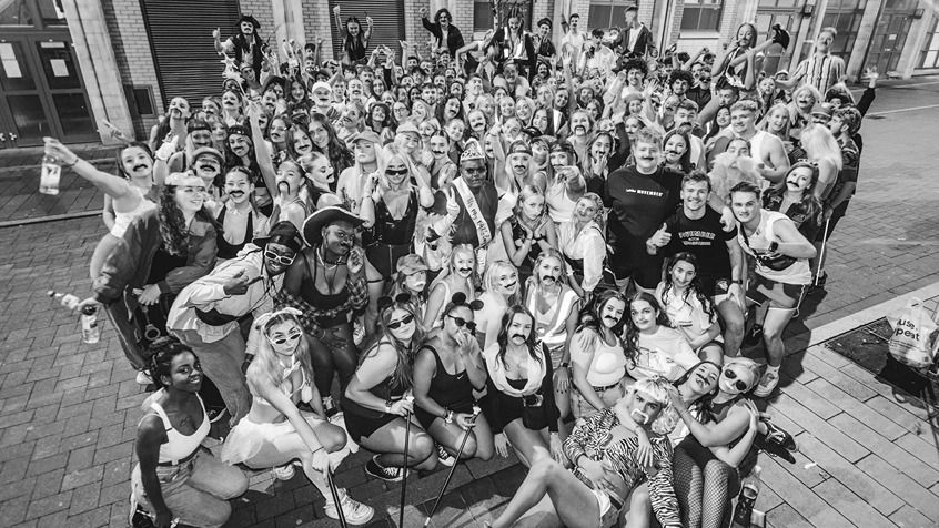 Large group of students posing for camera on campus for a Movember fundraising event