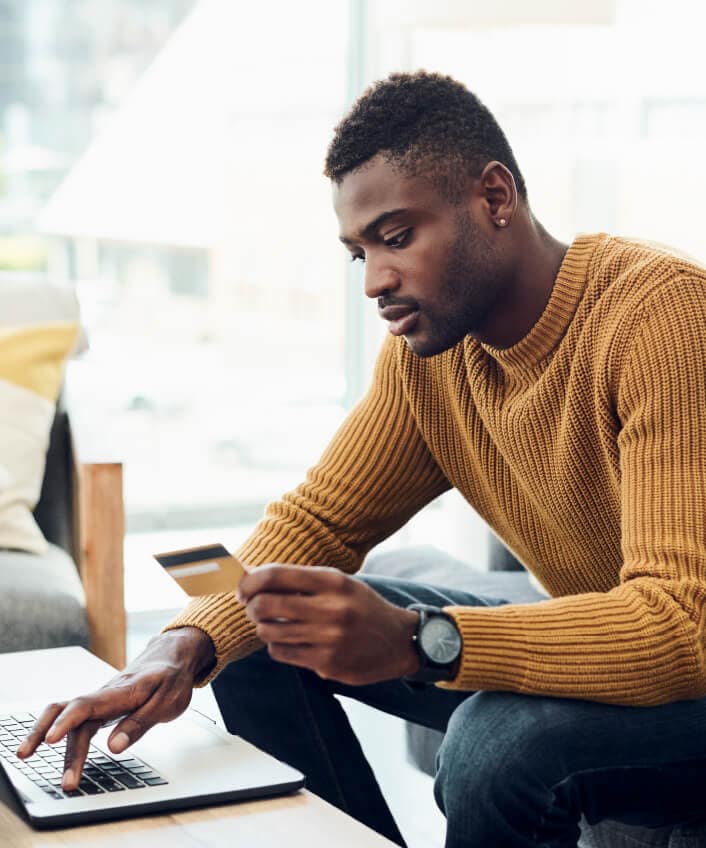 Man shopping on eBay from a laptop. 