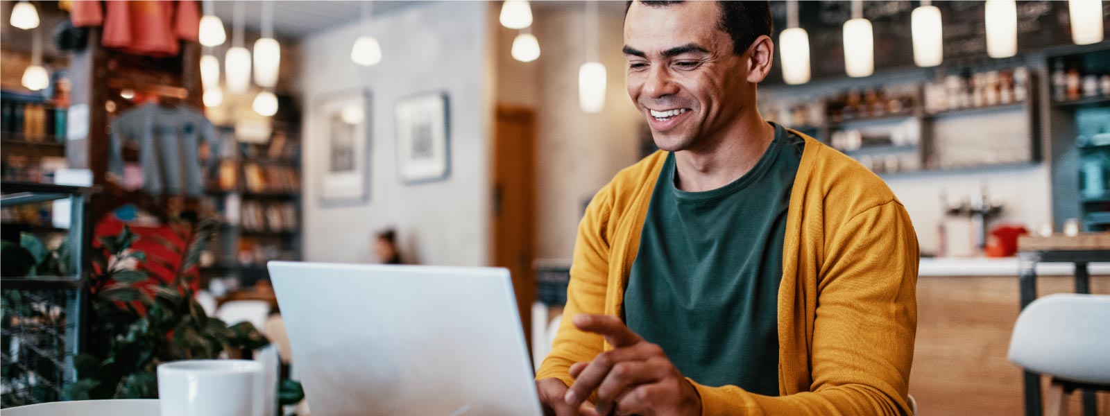 A man reads about an evil twin attack on his laptop.