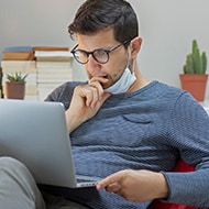 A man reading about how to protect himself from DocuSign phishing email attacks.