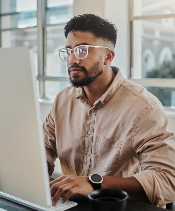 Man looking at his computer as he learns about malware.