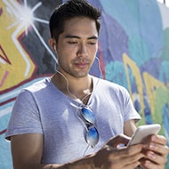 A person using a phone to research the safety of clicking on unsubscribe links.