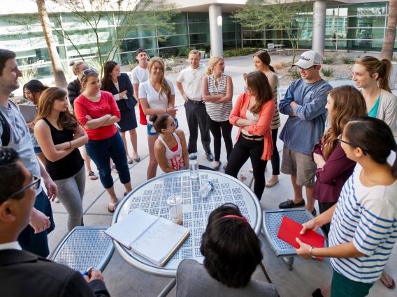 A group of students standing around a table