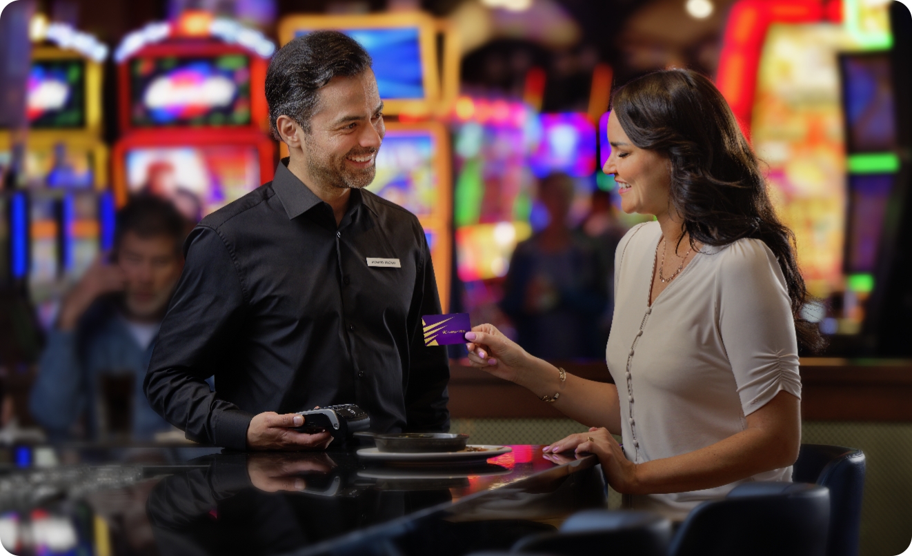 A Winner’s Edge member passes the card to casino staff.