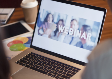 Laptop with word “Webinar” displayed on screen