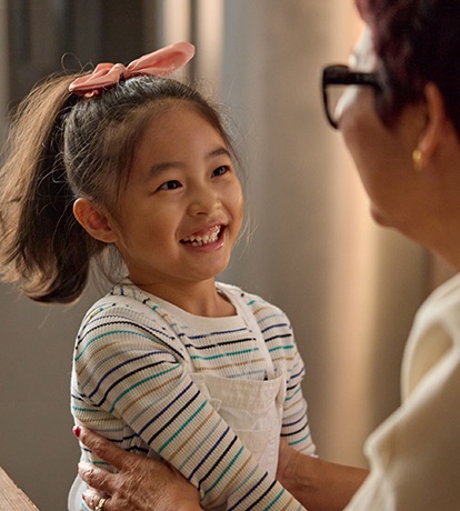 photo of a female child smiling at another older woman