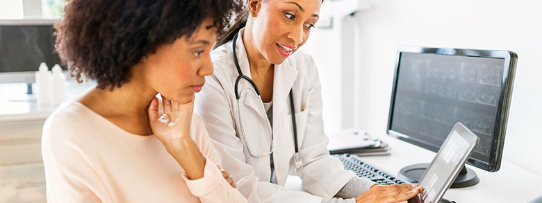 A health care professional showing a patient her scans.