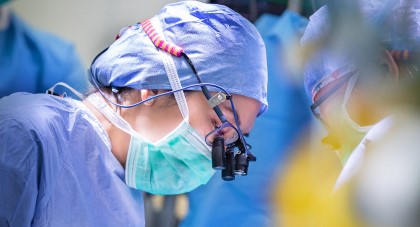 A surgeon wearing a mask in an operating room 