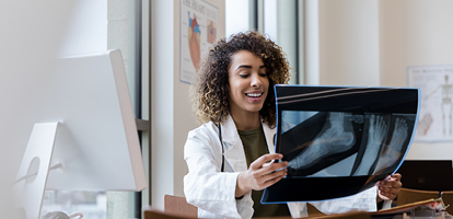 AHN doctor holding up an x-ray of a person's foot and ankle