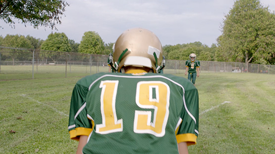 A football player facing away from the camera.