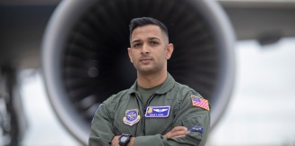 Pilot posing in front of jet turbine