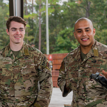 Airmen smiling and standing together