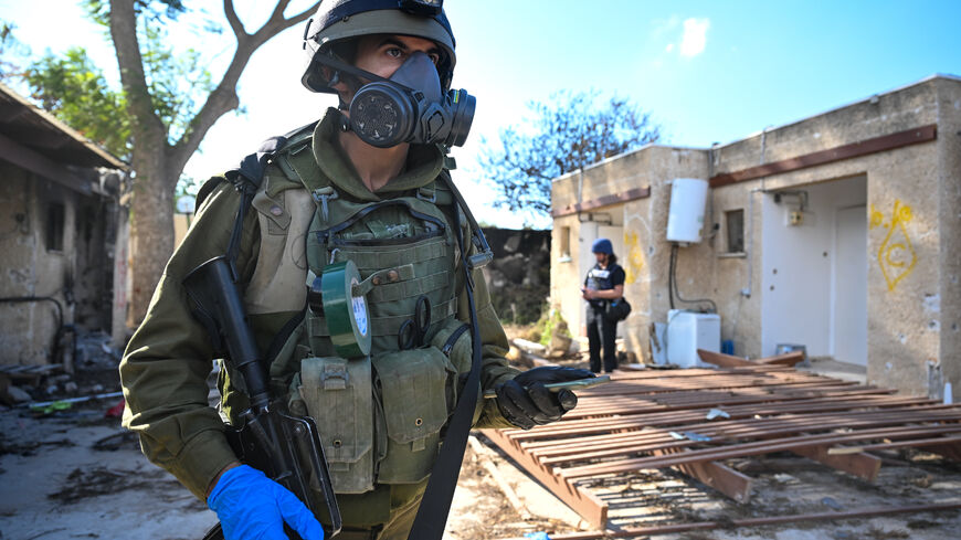  IDF soldiers move through neighborhoods destroyed by Hamas militants after they attacked this kibbutz days earlier near the border of Gaza on October 15, 2023 in Kfar Aza, Israel. Israel has sealed off Gaza and launched sustained retaliatory air strikes, which have killed at least 1,400 people with more than 400,000 displaced, after a large-scale attack by Hamas. On October 7, the Palestinian militant group Hamas launched a surprise attack on Israel from Gaza by land, sea, and air, killing over 1,300 peopl