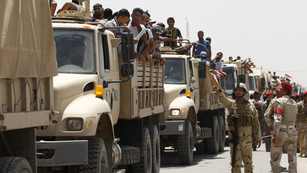 Volunteers, who have joined the Iraqi Army to fight against the predominantly Sunni militants who have taken over Mosul and other Northern provinces, travel in army trucks in Baghdad June 14, 2014. Iraqi Prime Minister Nuri al-Maliki told army officers in the city of Samarra that volunteers were arriving to help defeat Islamist militants who have swept through Sunni Muslim territory towards Baghdad. REUTERS/Thaier Al-Sudani  (IRAQ - Tags: CIVIL UNREST POLITICS MILITARY) - RTR3TQL8