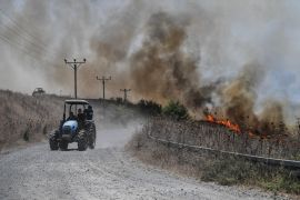 Fires blaze near a road, after Lebanon&#039;s Hezbollah said it launched more than 200 rockets and a swarm of drones at Israeli military sites, in the Israeli-occupied Golan Heights [Gil Eliyahu/Reuters]