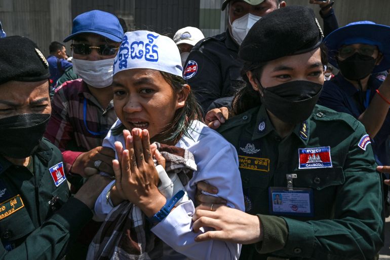 Cambodian environmental activist Phuon Keoraksmey is arrested outside the Phnom Penh municipal court after a verdict in Phnom Penh on July 2, 2024. - A Cambodian court on July 2 sentenced 10 environmentalists to between six and eight years in jail for plotting to commit crimes in their activism -- the latest legal crackdown on the country's green campaigners. (Photo by TANG CHHIN SOTHY / AFP)