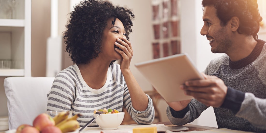 Man showing frame to woman, who looks happy