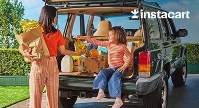 mother and daughter unloading groceries from the car