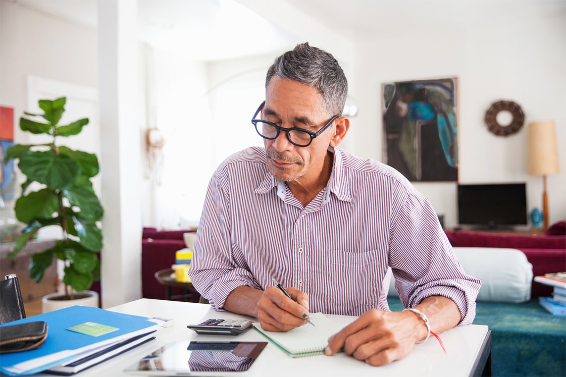 Man sitting at a desk looking over papers