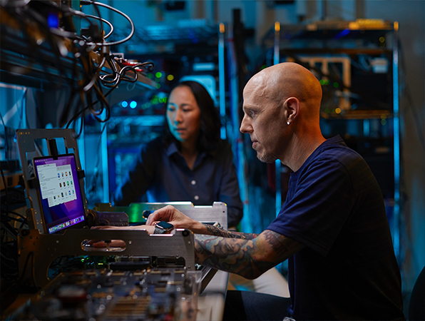 Dos empleados de Apple especializados en hardware trabajan en un laboratorio.