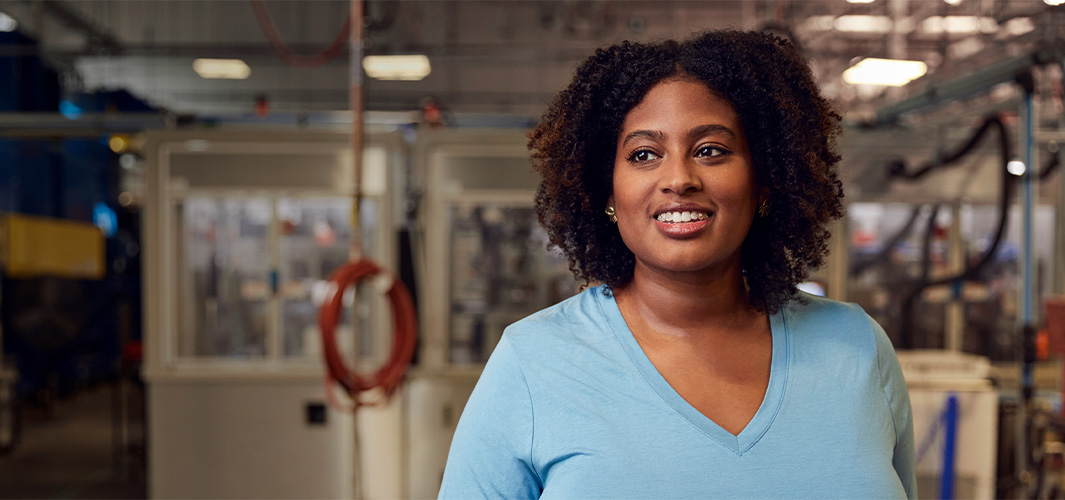 Camara in the Material Recovery Lab, smiling and looking to the side.