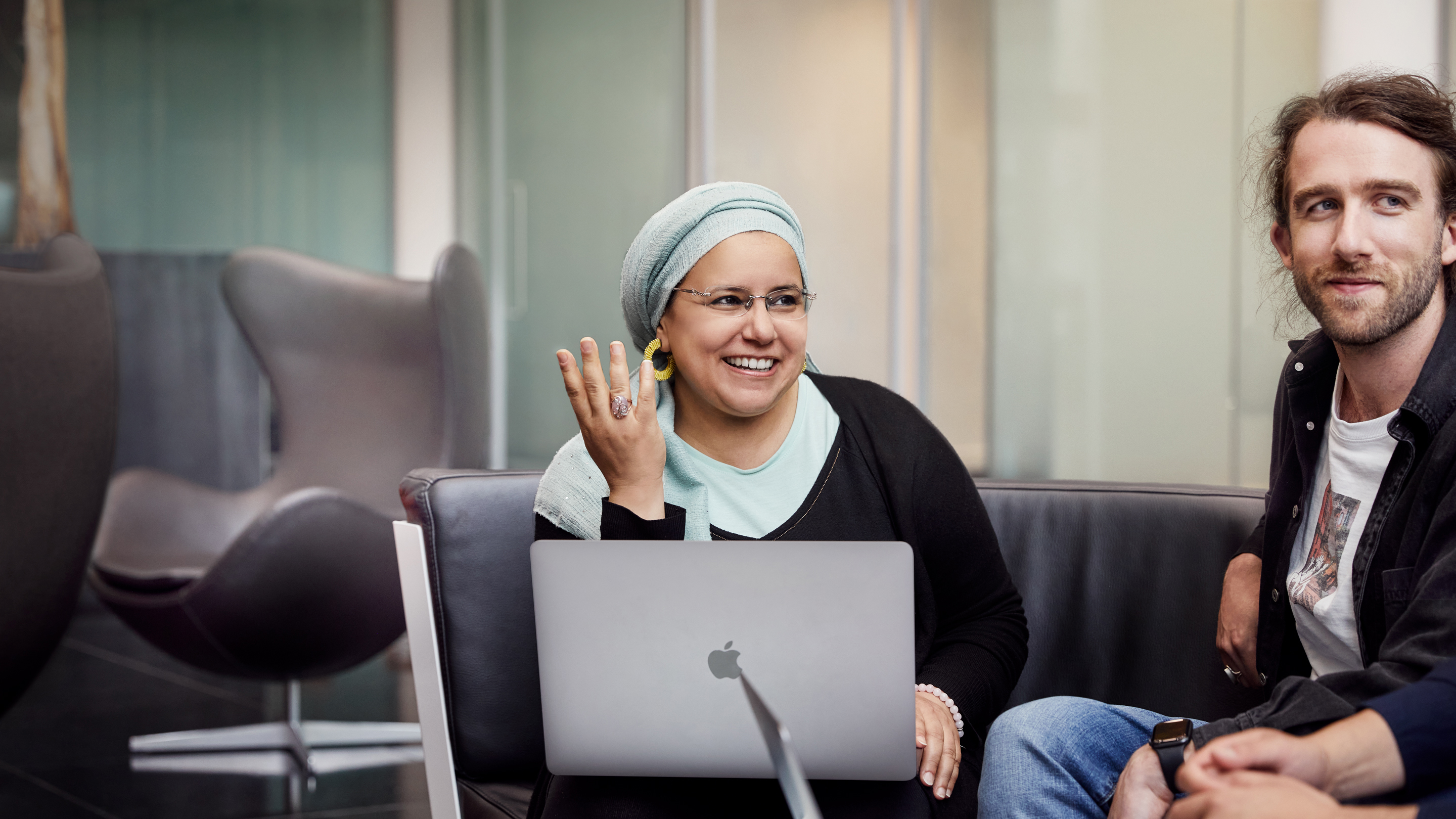 Apple Cork employees sitting together and collaborating.