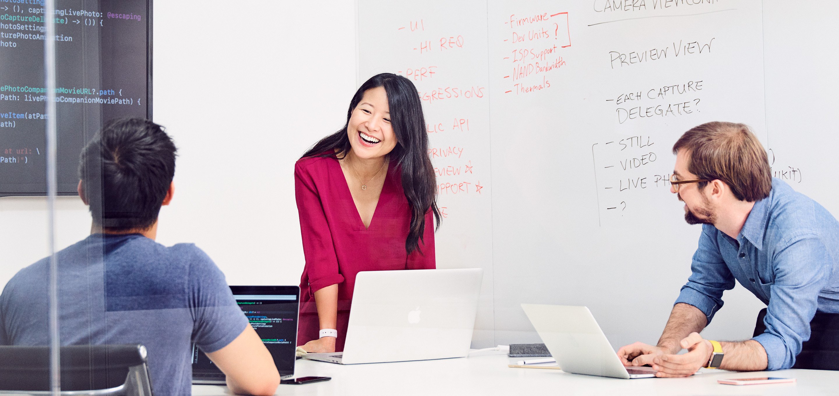 Un grupo de ingenieros de software de Apple comenta un proyecto en la sala de reuniones